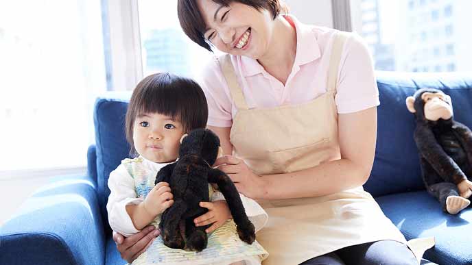 キッズスペースでぬいぐるみで遊ぶ幼児