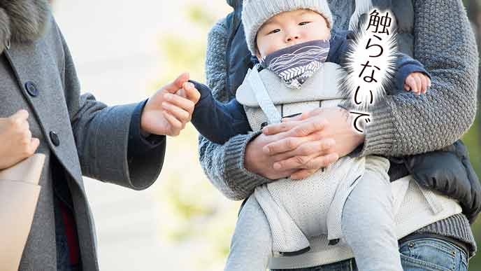 赤ちゃんの手を握るおばさん